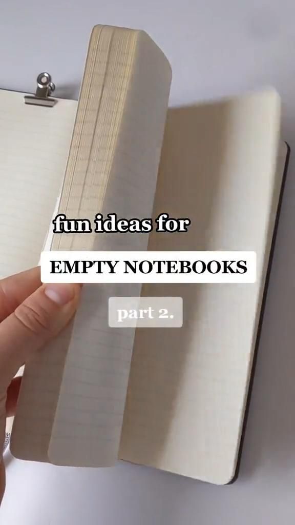 a hand holding an empty notebook with the words 10 fun ideas for empty notebooks