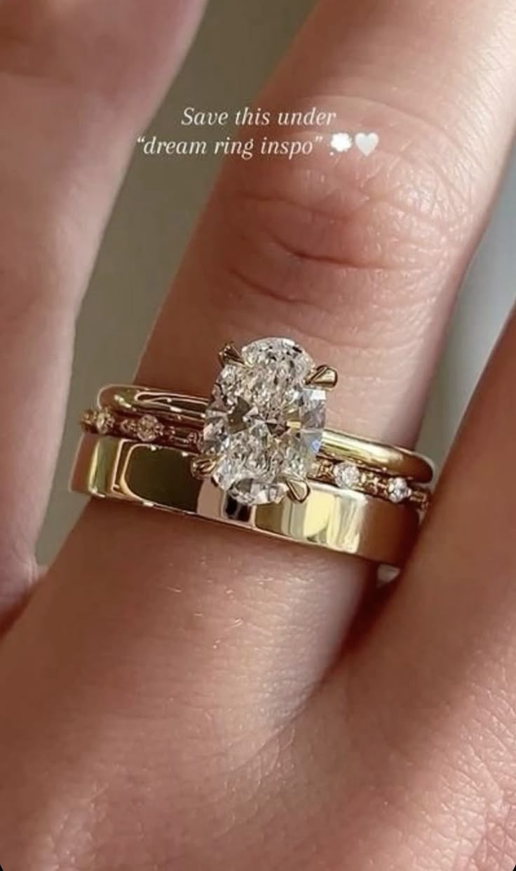 a woman's hand with a gold wedding ring and diamond engagement band on it