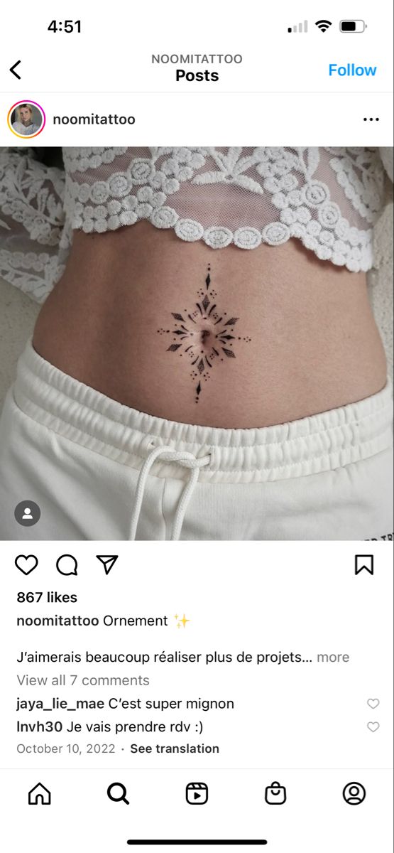 a woman's stomach with a small tattoo on it