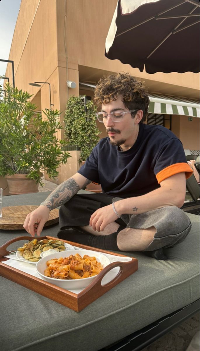 a man sitting on top of a table eating food