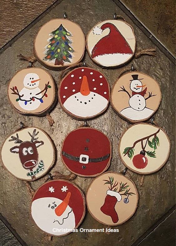 twelve decorated wooden christmas ornaments on a table