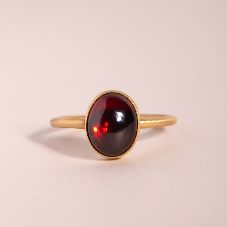 A delicious ring, set in 18k gold with a slick, juicy garnet cabochon. Luxury Ruby Ring Oval Cabochon Polished Finish, Luxury Ruby Ring Oval Cabochon With Polished Finish, Luxury Ruby Ring With Oval Cabochon And Polished Finish, Timeless Cabochon Sapphire Ring Gift, Elegant Hallmarked Garnet Birthstone Ring, Timeless Gift Sapphire Cabochon Ring, Classic Yellow Gold Garnet Rings, Yellow Gold Garnet Ring With Polished Finish, Classic Garnet Rings With Bezel Setting