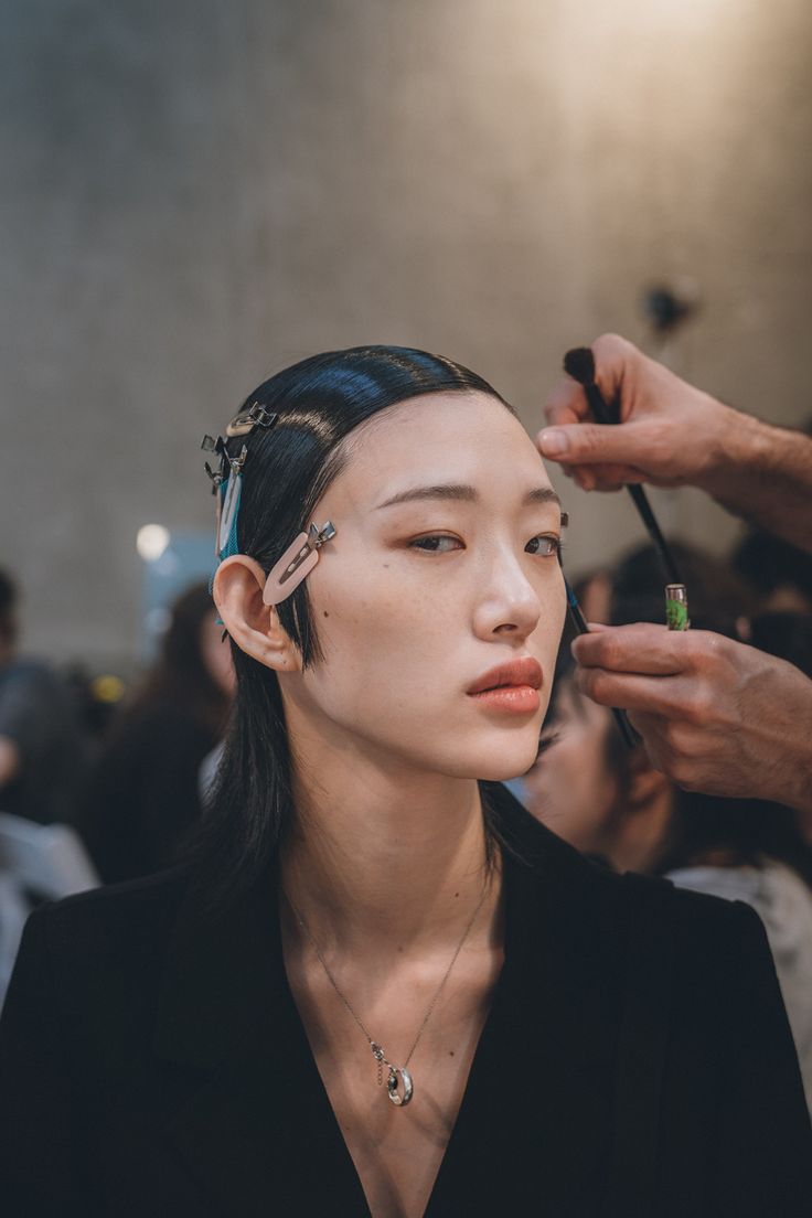 a woman getting her makeup done at a beauty salon