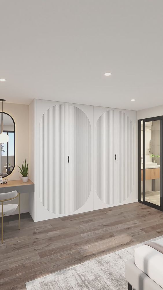 a living room filled with furniture and lots of white closet doors in front of a mirror