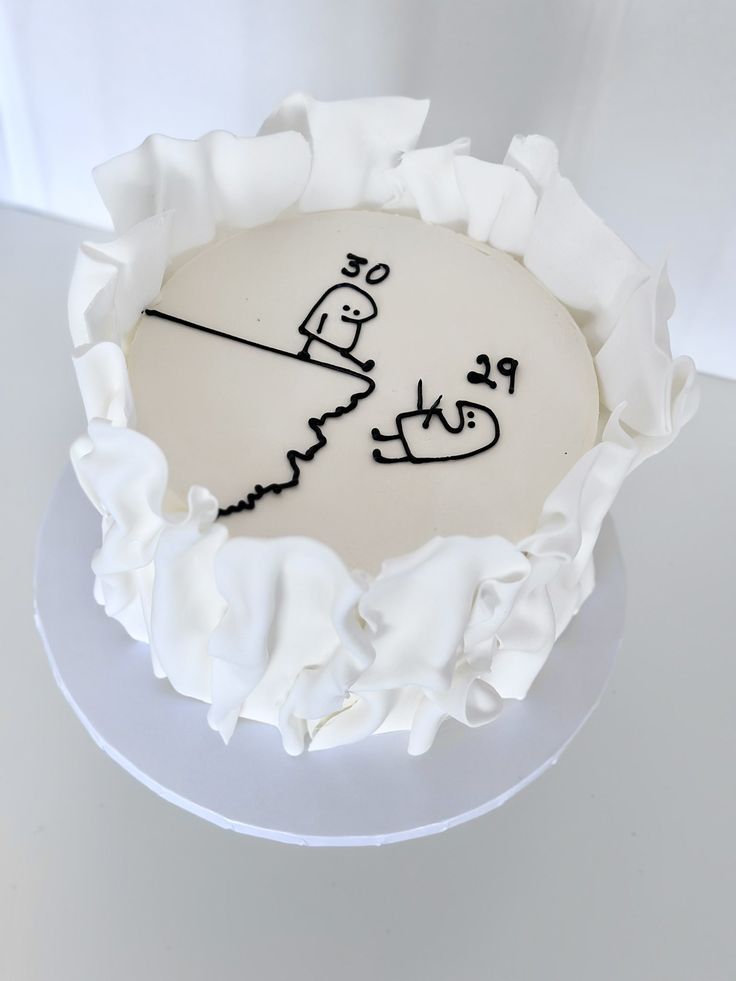 a cake with writing on it sitting on top of a white tablecloth covered plate