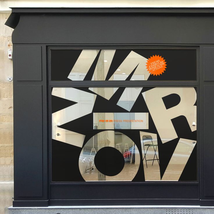 a store window with an orange sticker on it's glass and the words new york written in bold letters