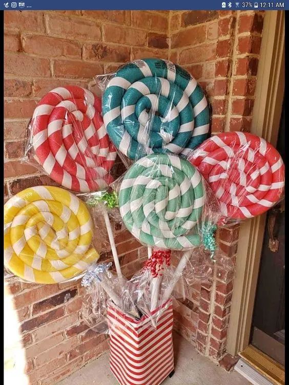 some lollipops are sitting in a bucket on the front door sill