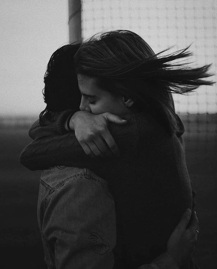 black and white photograph of two people hugging each other