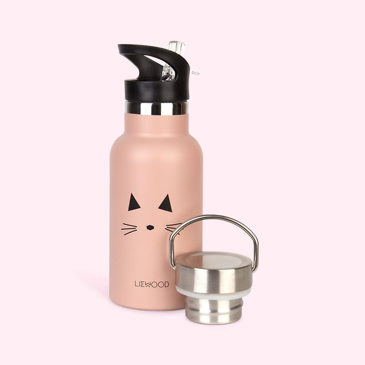 a pink water bottle with a cat face on the side and a stainless steel cup next to it