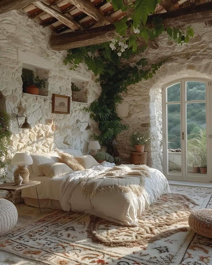 a bedroom with stone walls and plants on the ceiling