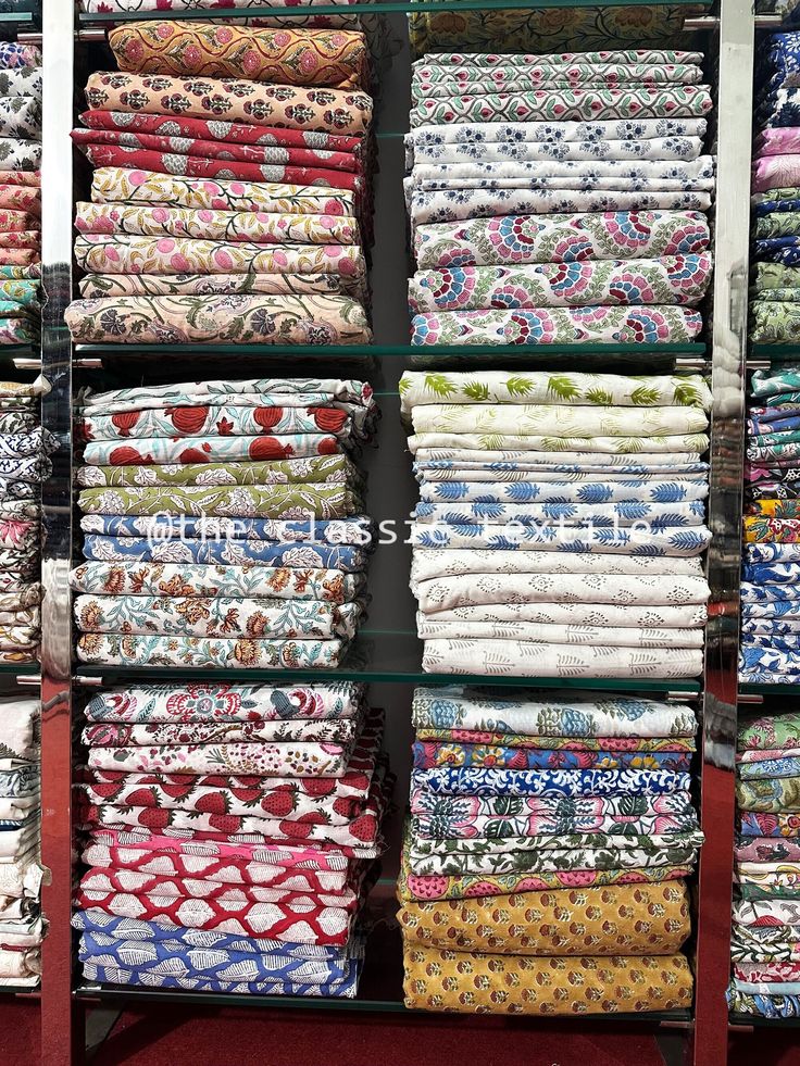 a display case filled with lots of different colored fabrics