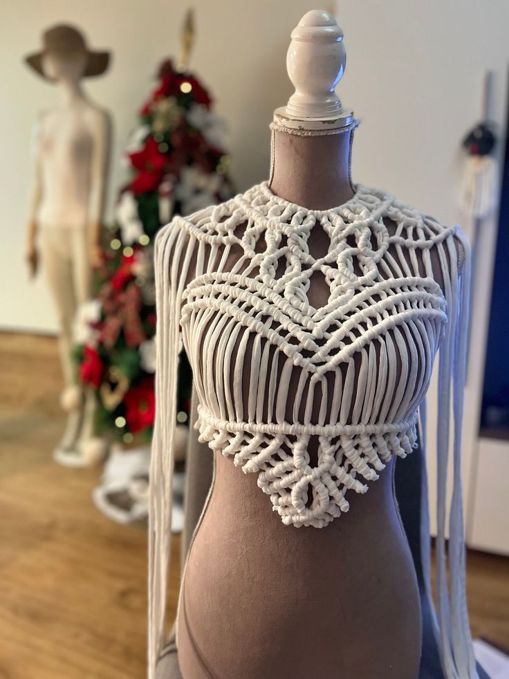 a mannequin with white crochet on it's torso and neck