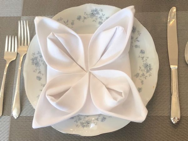 a white plate topped with a napkin and silverware