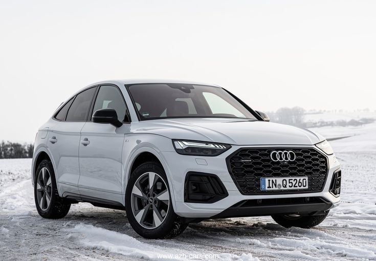 a white audi suv parked in the snow