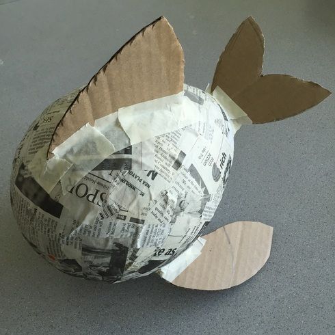 an origami fish made out of newspaper paper