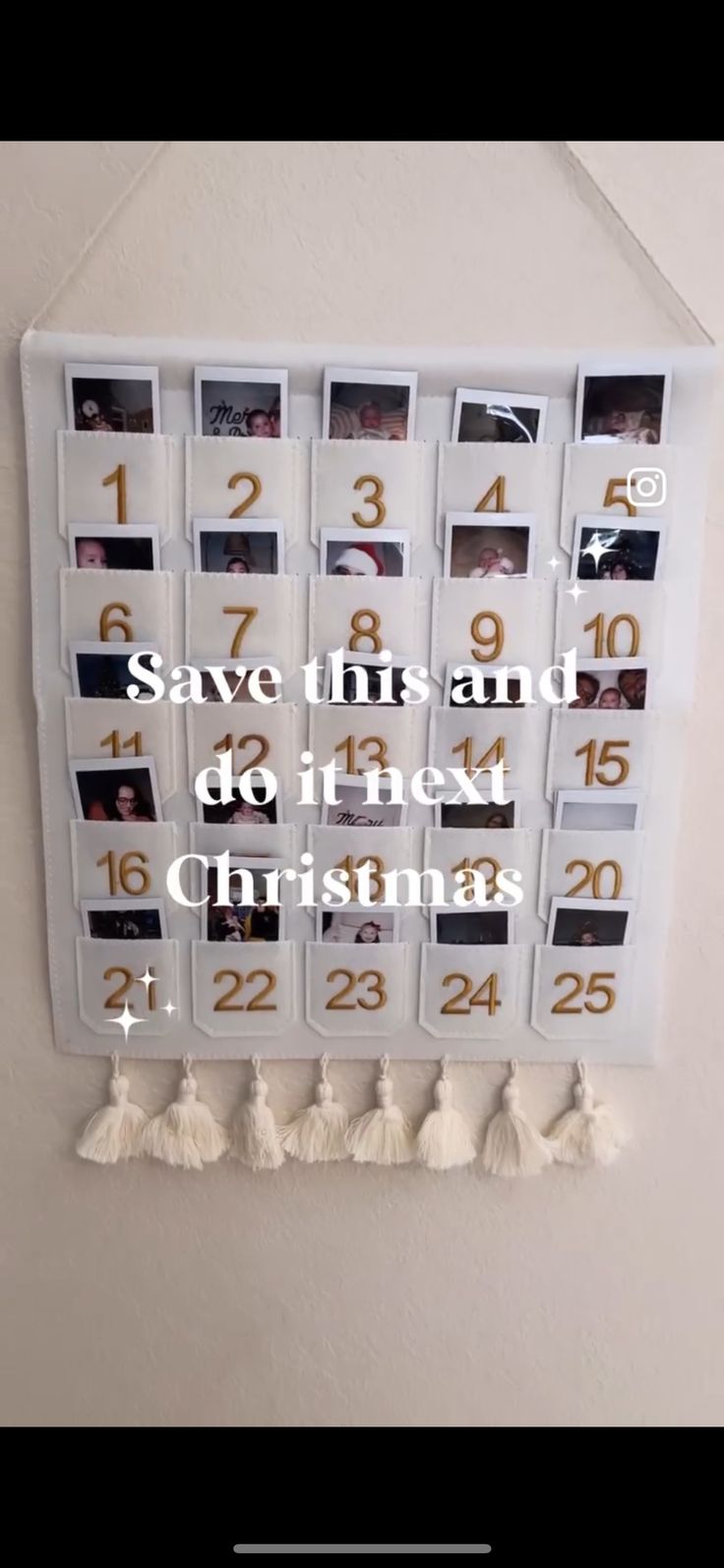 a calendar hanging on the wall with photos and tassels attached to it's sides