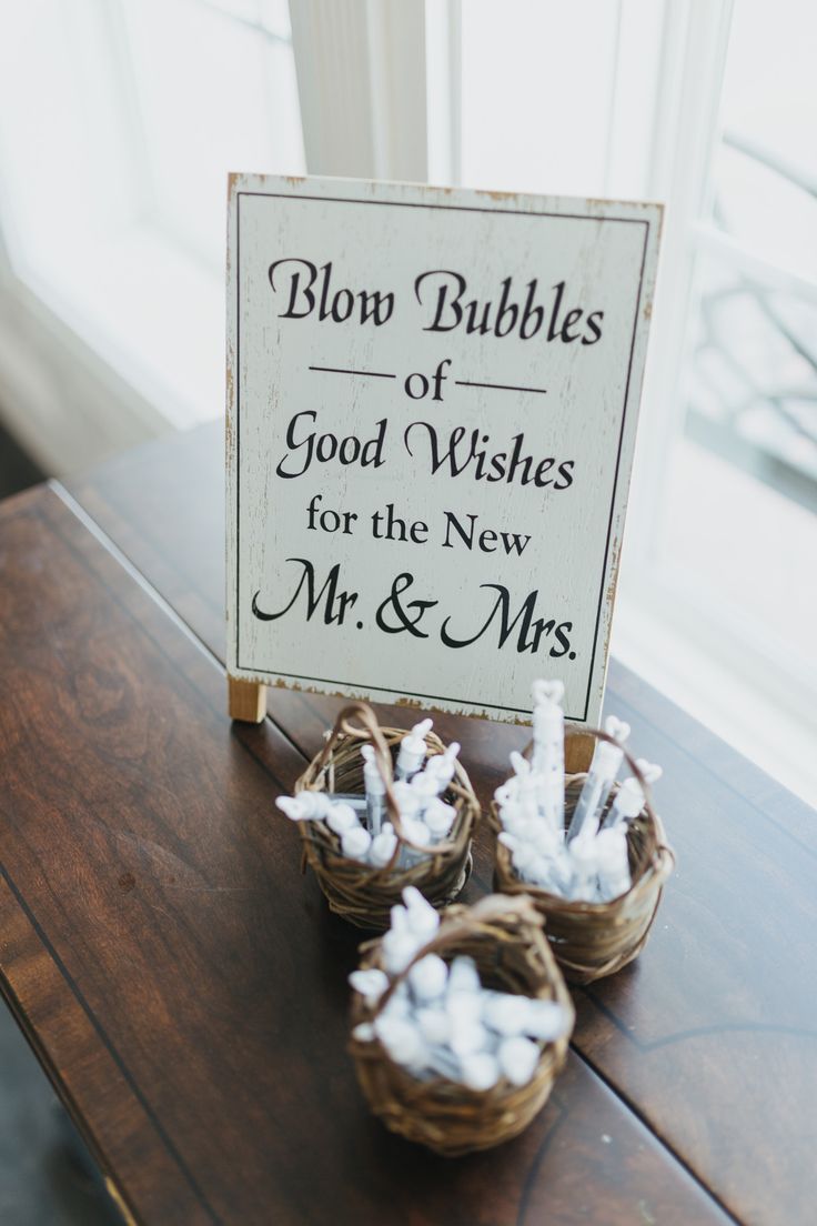 two baskets filled with marshmallows sitting on top of a table next to a sign