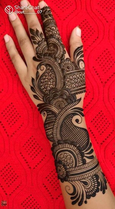 a woman's hand is decorated with hennap and intricate designs on it