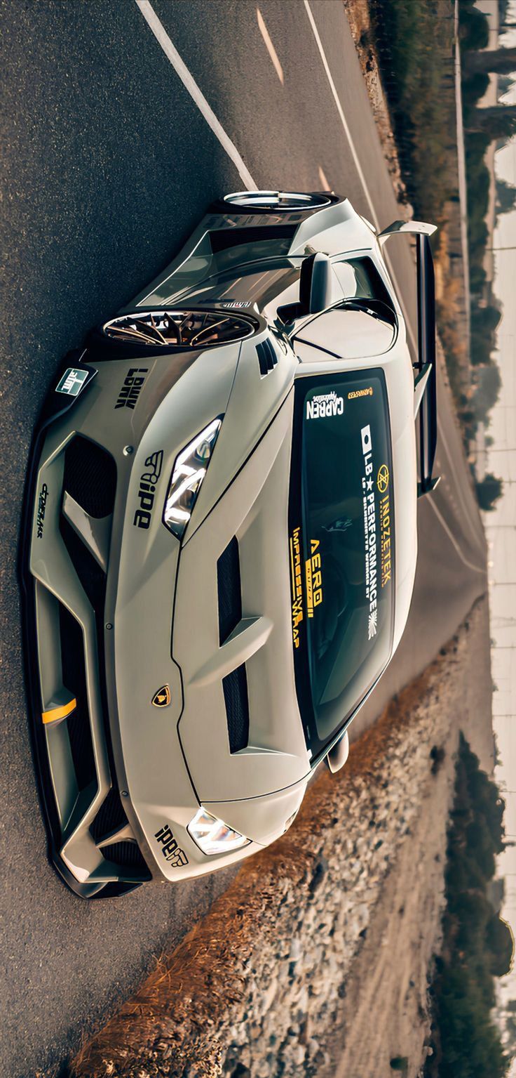 a sports car is parked on the side of the road