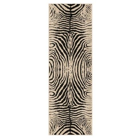 a zebra print rug with black and white stripes