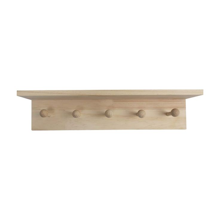 a wooden shelf with three knobs on the top and two holes in the bottom