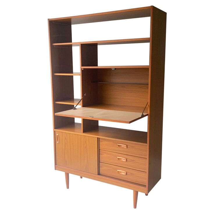 a wooden bookcase with drawers and a desk top on one side, against a white background