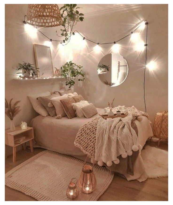 a bedroom with white walls and lots of lights on the headboard, rugs and pillows