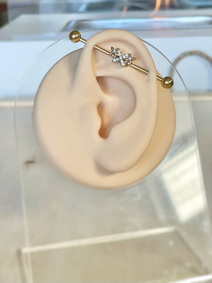 a pair of ear piercings sitting on top of a glass display case