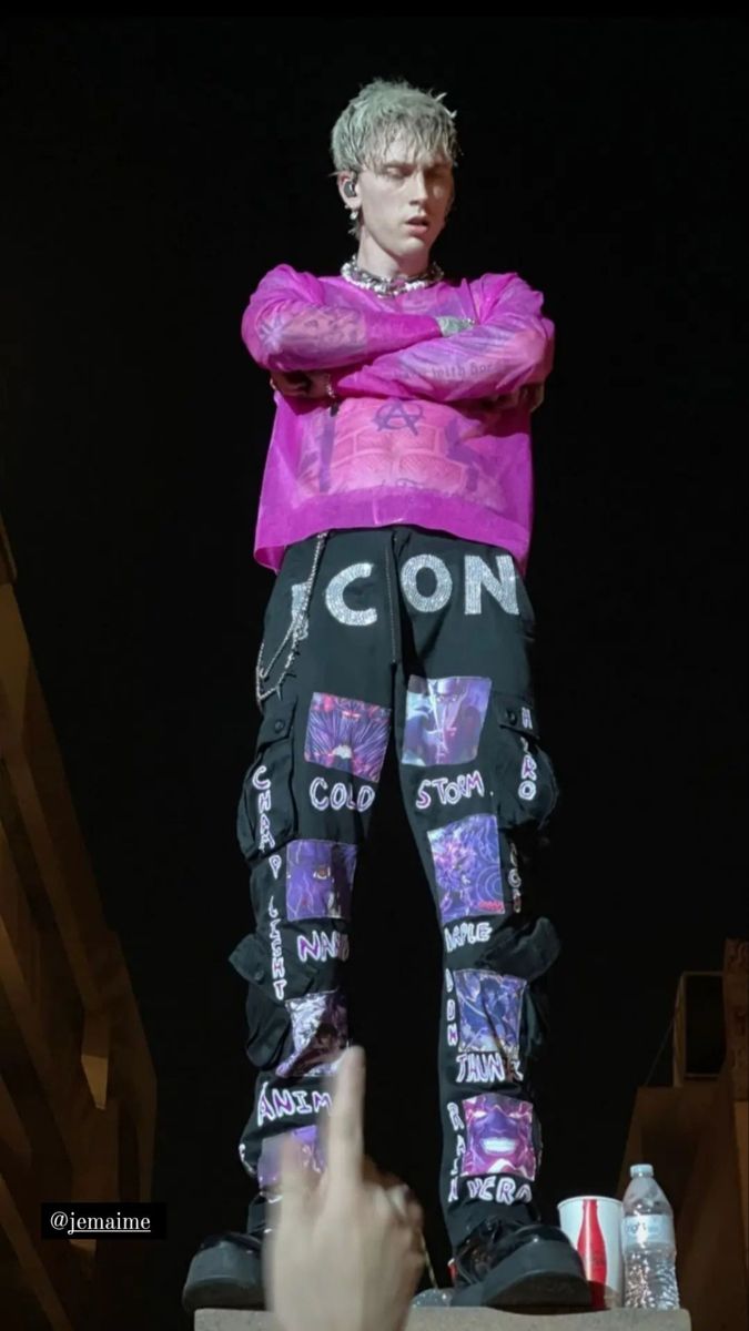 a male in a pink shirt and black pants