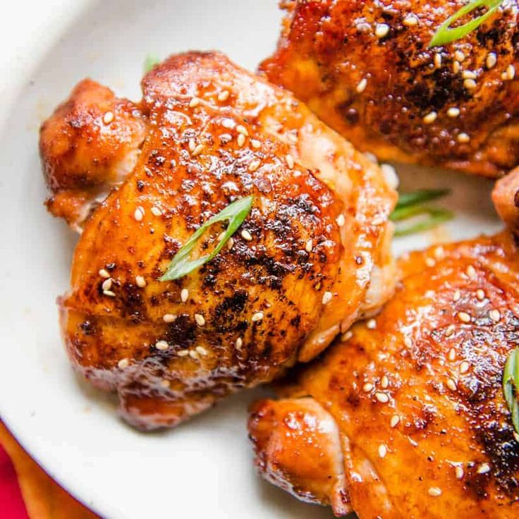 chicken with sesame seeds and herbs on a white plate