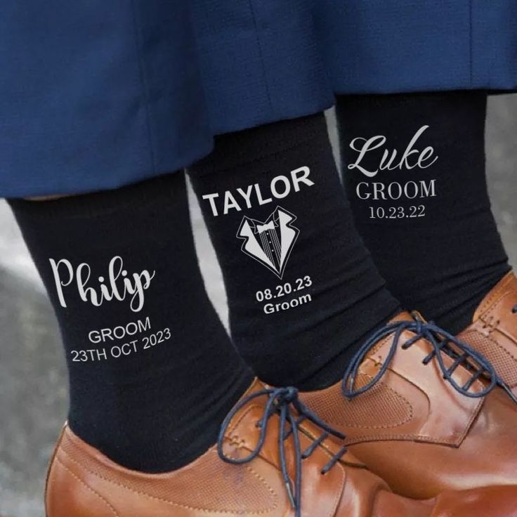 two men's socks with the names of their groom and brides on them