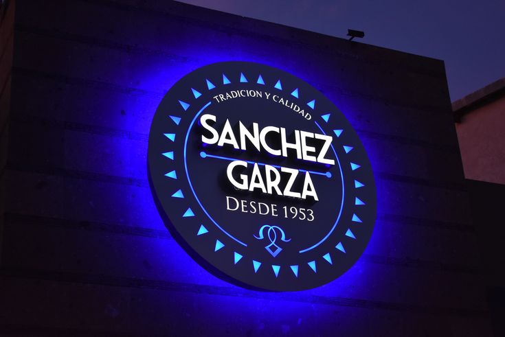 the sign for sanchez gazza is lit up in blue and purple lights