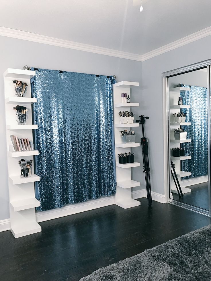 a living room filled with furniture and a blue curtain