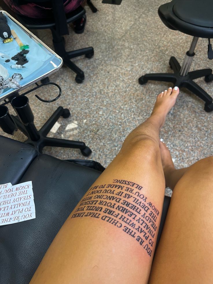 a woman's leg with words written on it