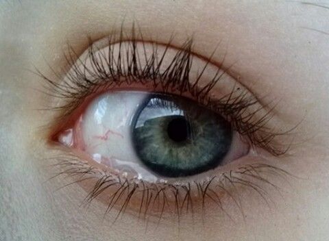 an eye with long lashes and blue eyes