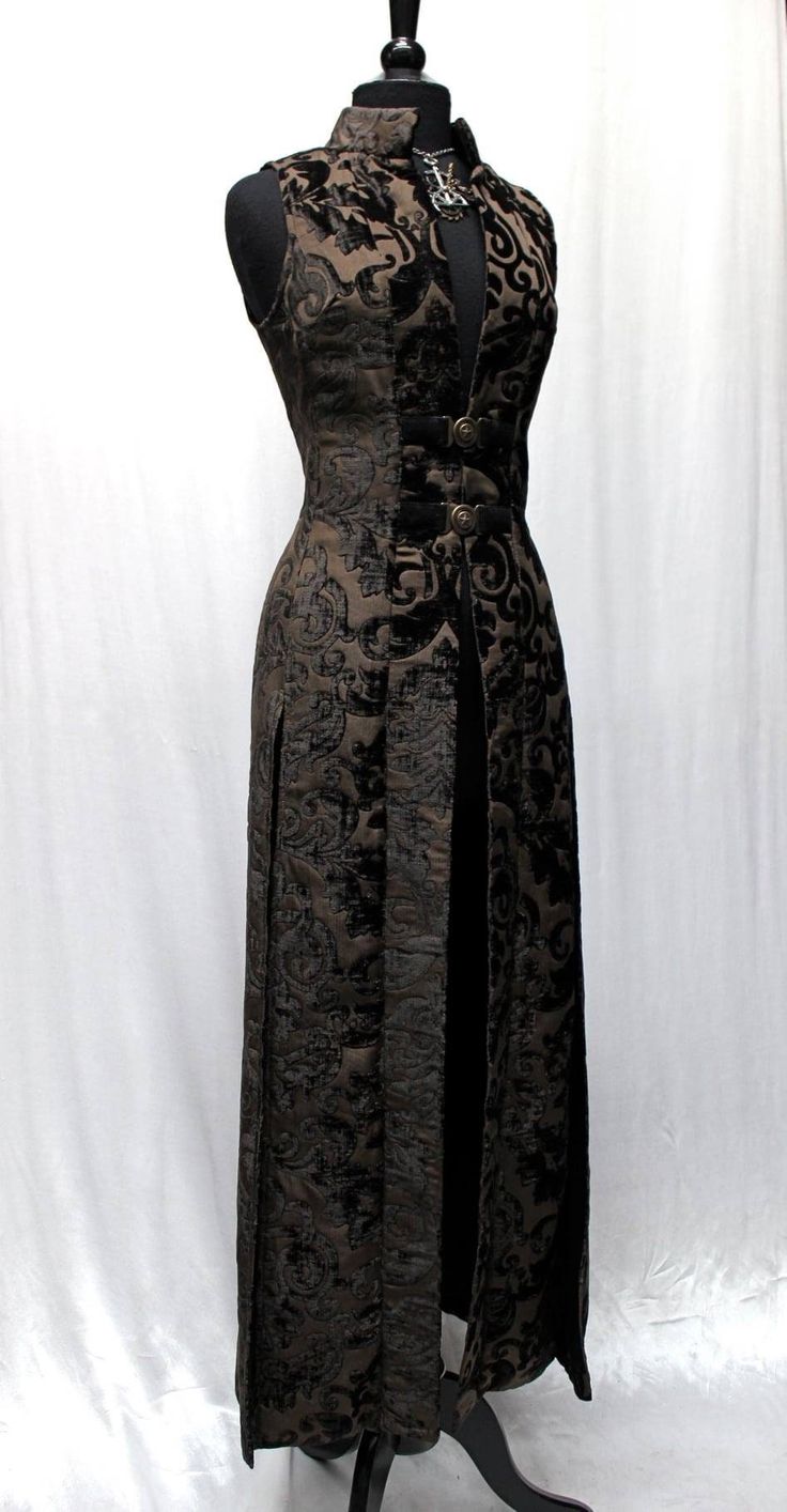 "Gorgeous raiment. A dramatic women's cassock coat made in lush dark coffee brown velvet print fabric. Sleeveless with a classic stand-up collar and a slimming fit. Slits in the back sides and front for flowing ease of movement. Fastens in front with two ornate bronze buckles and lined on the inside in sleek black satin. Comes in sizes Small-3X T. O. D. I. E. F. O. R :) Size measurements: Small - Chest 34\" Waist 30\" Hips 38\" Medium - Chest 36\" Waist 32\" Hips 40\" Large - Chest 38\" Waist 34 Dark Coffee, Brown Velvet, Coffee Brown, Fantasy Clothing, Fantasy Fashion, Cosplay Outfits, Small Chest, Character Outfits, Historical Fashion