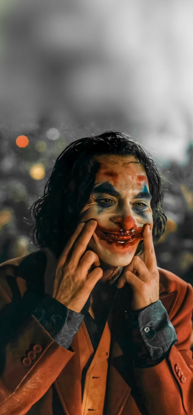 a man with his face painted like a clown in front of a cityscape