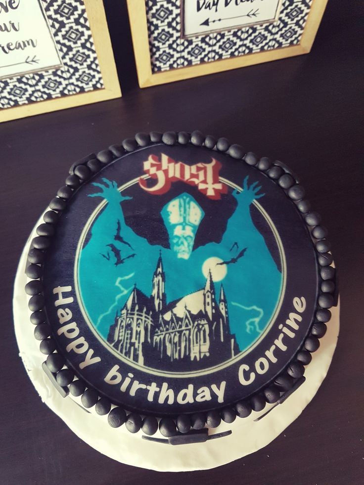 a birthday cake with an image of a ghost on the front and back of it