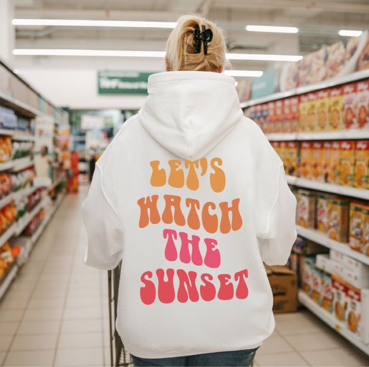 Let's Watch The Sunset Hoodie ,Oversized Hoodie, Pinterest Hoodie, Words On Back Hoodie, VSCO, Aesthetic Sweatshirt If you like to wear a comfortable fit or oversized, we recommend choosing 1 or 2 sizes larger. A unisex heavy blend hooded sweatshirt is relaxation itself. The material is a thick blend of cotton and polyester. This makes for a plush, soft feel alongside warmth. It's also a great surface for printing. There are no side seams. A spacious kangaroo pocket hangs in front. The hood's dr Lets Watch The Sunset Hoodies, Let’s Watch The Sunset Hoodie, Have A Good Day Hoodie, Preppy Hoodie, Sunset Hoodie, Tee Outfits, Motivational Hoodies, Positive Hoodie, Aesthetic Sweatshirt