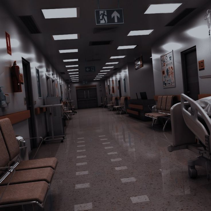 an empty hospital hallway with chairs and lights