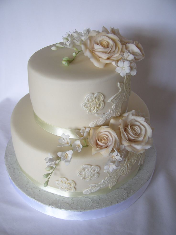 two tiered wedding cake decorated with white flowers