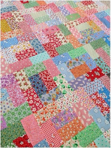 a colorful patchwork quilt with many different colors and patterns on it's sides