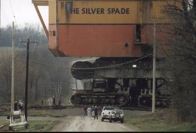 an old train sitting on the side of a road