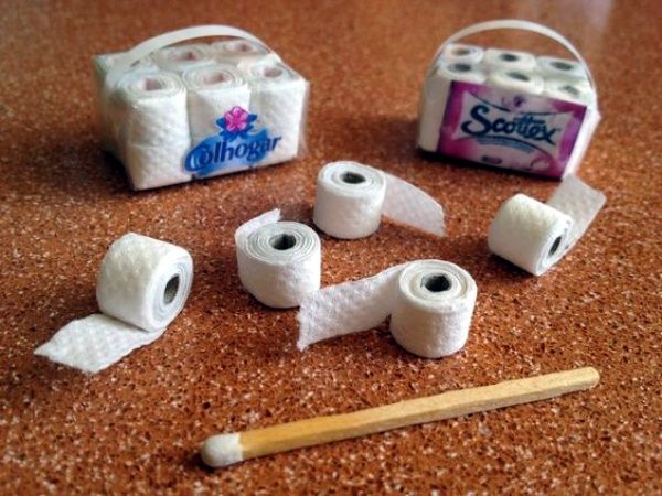 several rolls of toilet paper sitting on top of a table next to a pair of scissors