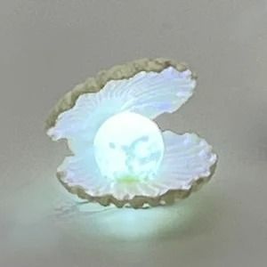 a white ring with an image of a bird on it's side and the light shining through its wings