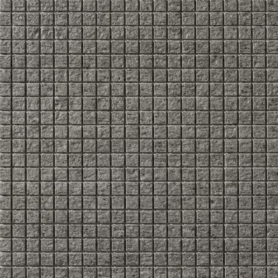 a gray tile wall with small squares on it