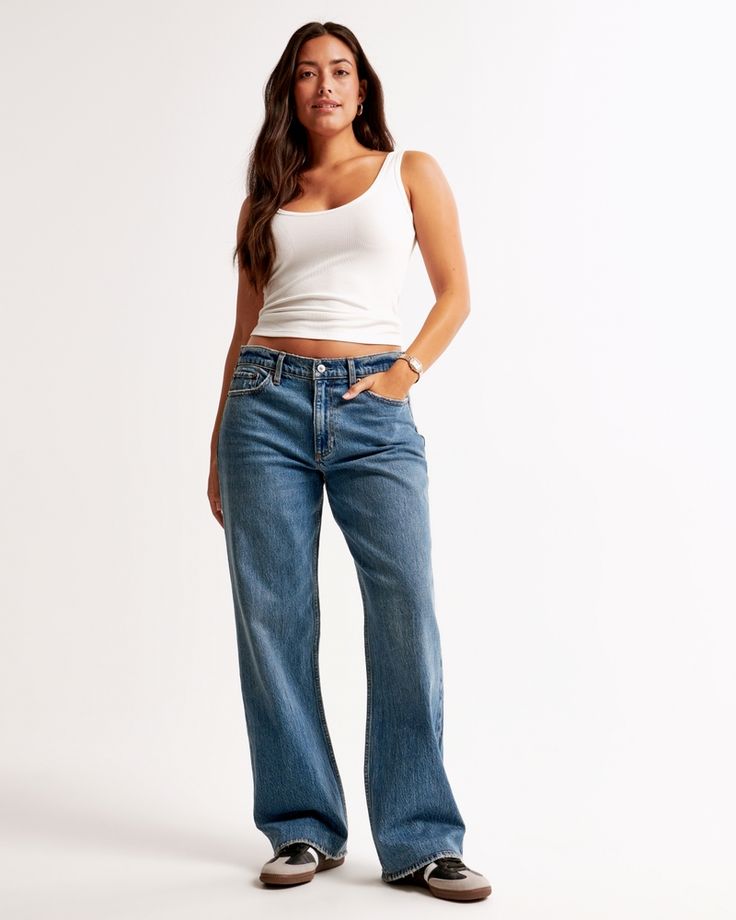 Our Curve Love low rise baggy jeans in a medium wash with a clean hem. This fit features a 8.5” low rise, is slightly relaxed at waist and hips, and eases at the thigh into a baggy, full-length leg shape. We recommend buying your true size for a baggier fit. Size down for a closer fit. The viral fit that eliminates waist gap: Curve Love features additional room through the hip and thigh for curve-hugging comfort. This jean is made from our vintage stretch fabric which features both an authentic Jeans For Big Thighs, Low Rise Baggy Jeans, Baggy Jeans Outfit, Baggy Jean, Low Waist Jeans, Women's Bottoms, Style Inspiration Fall, Loose Jeans, Low Rise Jeans