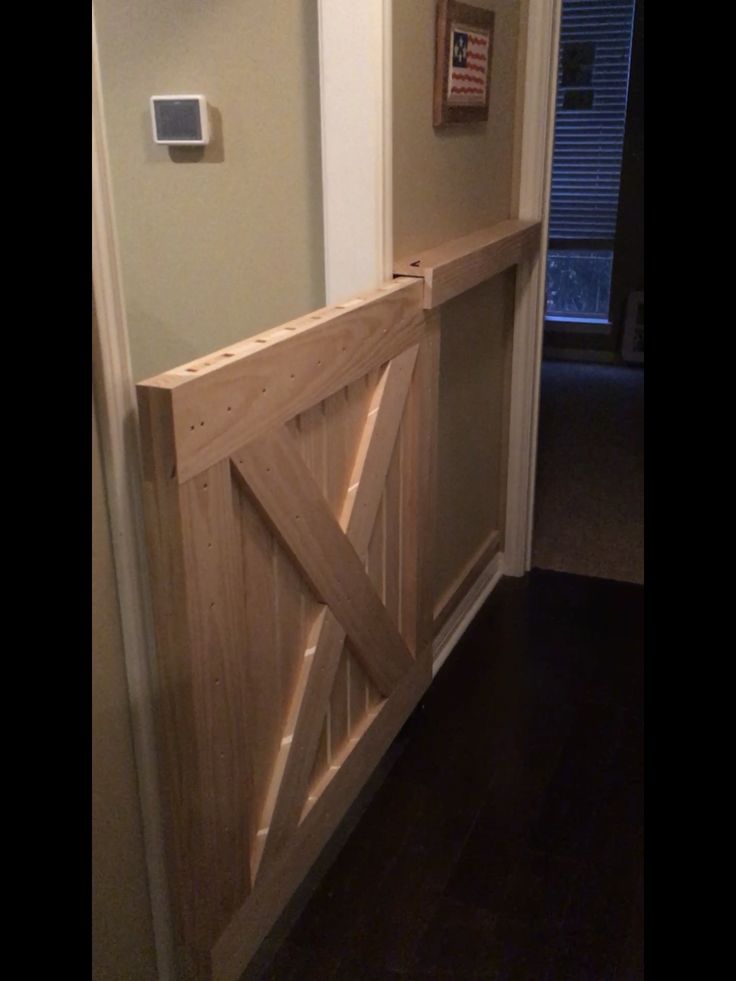 a wooden door is opened to reveal a room