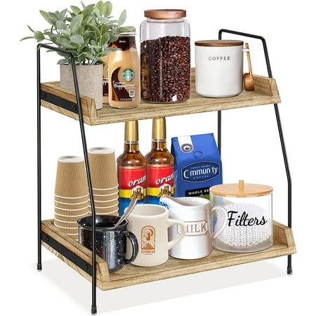 a three tiered shelf with coffee cups, mugs and other items on it