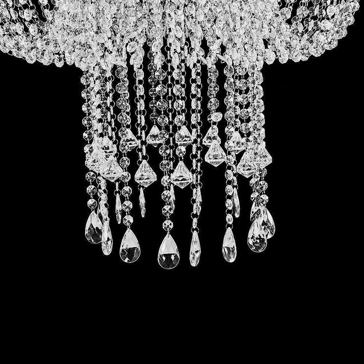 a chandelier hanging from the ceiling with many crystal drops and tears on it